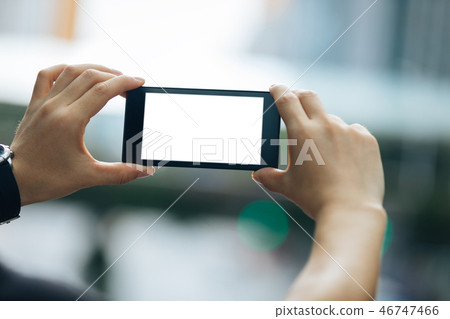 Hands hold smartphone take pictures in modern city Hands hold smartphone take pictures in modern city 46747466