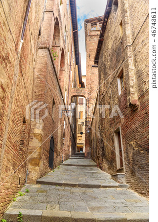 Medieval narrow street in Siena, Tuscany, Italy. Medieval narrow street in Siena, Tuscany, Italy. 46748611