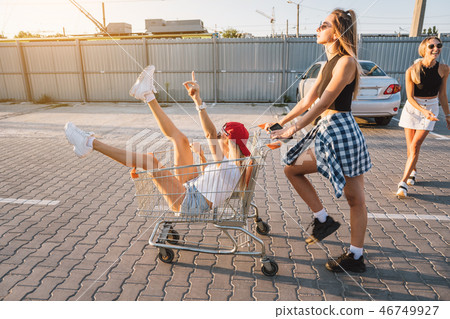 The girl carries her friend in a basket The girl carries her friend in a basket 46749927
