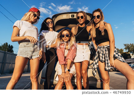 Five young women have fun at the car park. Five young women have fun at the car park. 46749930