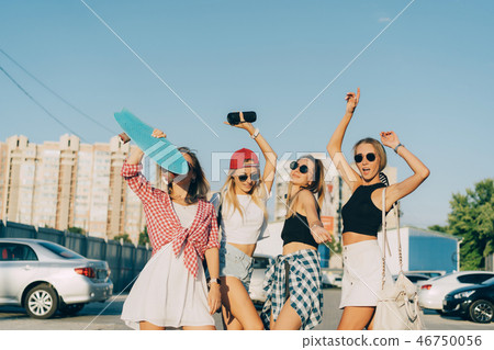Four young girls have fun at the car park. Four young girls have fun at the car park. 46750056