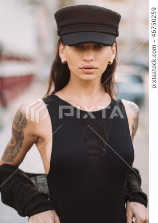 Sexy, young woman in leotard posing on camera in the streets Sexy, young woman in leotard posing on camera in the streets 46750259
