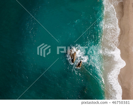 Aerial view of the ocean waves washing on the coast Aerial view of the ocean waves washing on the coast 46750381