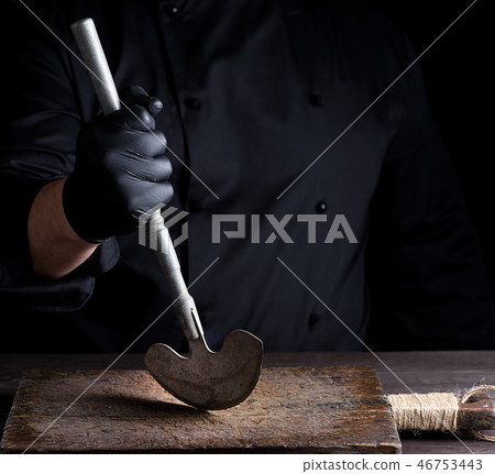 chef  holds in his hand a metal old knife 46753443