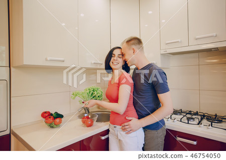 couple in a kitchen couple in a kitchen 46754050