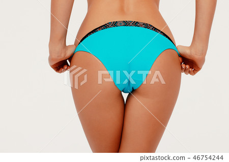Female butt, white background. Beautiful female butt in a Thong 46754244