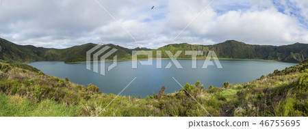 Panoramic landscape with beautiful blue crater lake Lagoa do Fogo from top of the hill on hiking Panoramic landscape with beautiful blue crater lake Lagoa do Fogo from top of the hill on hiking 46755695