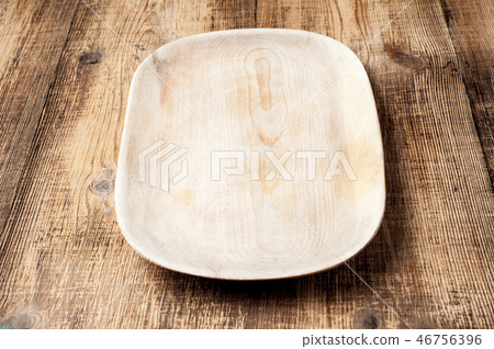 Blank wood plate on wooden rustic table. Blank wood plate on wooden rustic table. 46756396