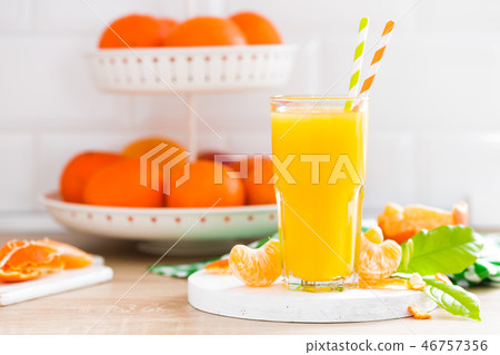 Tangerine orange juice in glass and fresh fruits 46757356