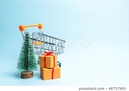 Christmas tree, supermarket cart and gift 46757903
