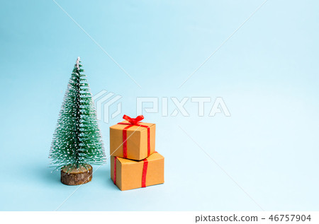 Christmas tree and gift on a blue background.  46757904