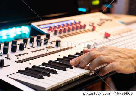 producer hands playing keyboard in sound studio producer hands playing keyboard in sound studio 46759960