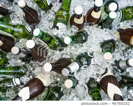 Cubes of ice and colorful bottles with cold beer 46760282