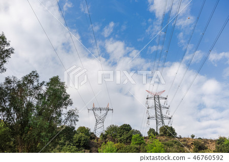 Electricity transmission towers against blue sky background Electricity transmission towers against blue sky background 46760592