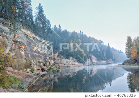Autumn landscape and red stone cliff of Gauja river, Latvia, Europe. 46763329