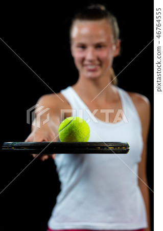 Young woman on a tennis practice. Beginner player holding a racket, learning basic skills. Portrait Young woman on a tennis practice. Beginner player holding a racket, learning basic skills. Portrait 46764555