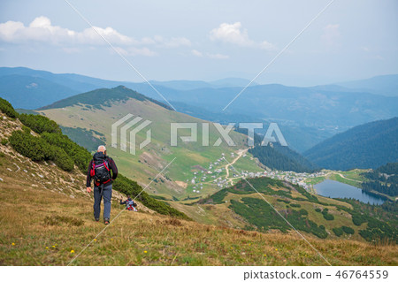Sporty hikers on path with trekking poles Sporty hikers on path with trekking poles 46764559