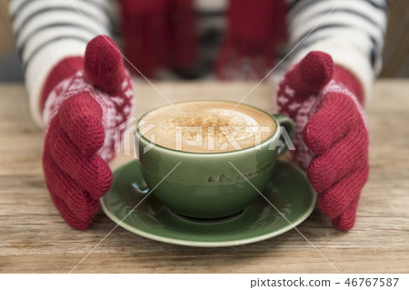 Hand in glove holding coffee 46767587