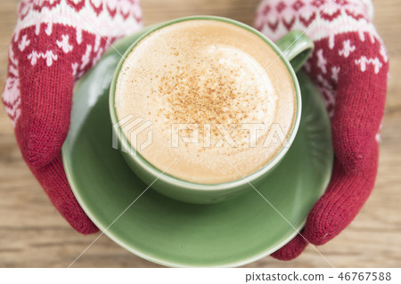 Hand in glove holding coffee 46767588