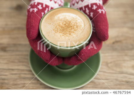 Hand in glove holding coffee Hand in glove holding coffee 46767594