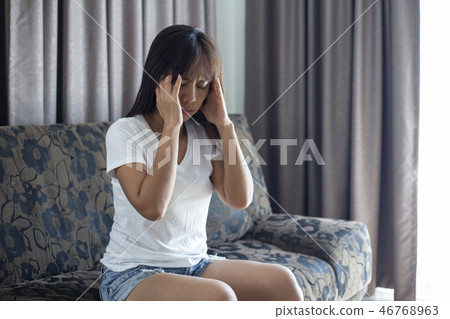 Asian Woman with hard headache holding hands  46768963