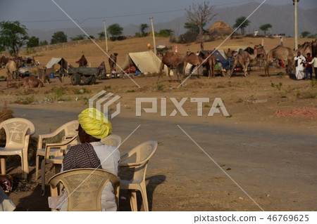 Indians resting in a canteen in the canteen collecting in the desert during the Pushkar camel festival in Rajasthan, India 46769625