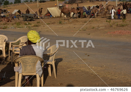 Indians resting in a canteen in the canteen collecting in the desert during the Pushkar camel festival in Rajasthan, India Indians resting in a canteen in the canteen collecting in the desert during the Pushkar camel festival in Rajasthan, India 46769626