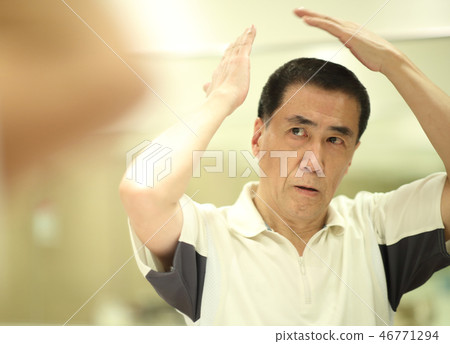Men in their 60s doing hair care Men in their 60s doing hair care 46771294