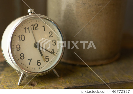 The white vintage clock alarm  near window light. 46772537