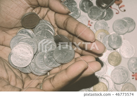 Woman holding Stock pile of Indian coin currency. 46773574