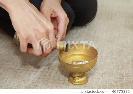 Pouring water from bottle into cup for share good 46775523
