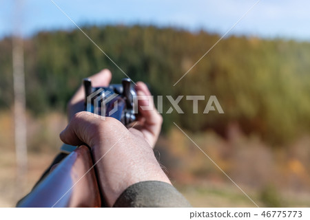Hunter with retro shotgun aims at the target Hunter with retro shotgun aims at the target 46775773