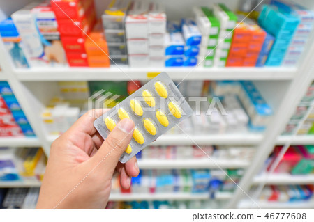 Hand holding medicine pack in drugstore Hand holding medicine pack in drugstore 46777608