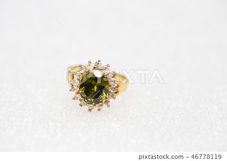 Beautiful gold ring with green gemstone 46778119