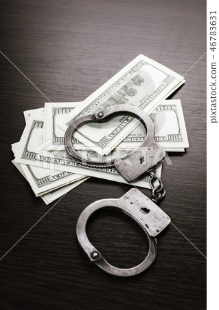 handcuffed and paper money handcuffed and paper money 46783631