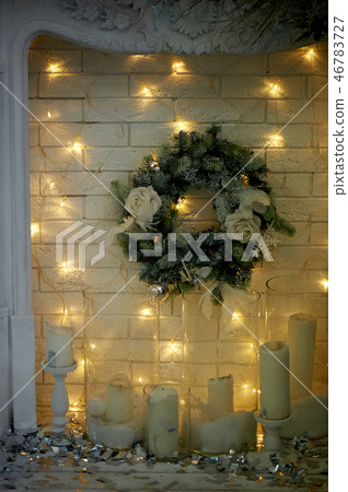 Decorative fireplace decorated with garlands. Christmas decoration of the house.Comfort Decorative fireplace decorated with garlands. Christmas decoration of the house.Comfort 46783727
