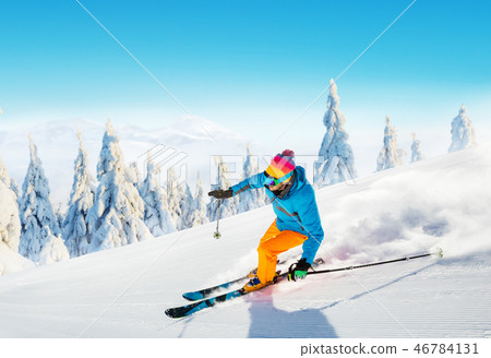 Young man skiing on piste 46784131