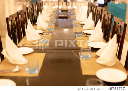 Selected focus of empty glass of water on dinner table with napkin. 46785737