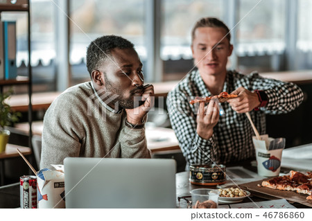 Thoughtful bearded male person touching his chin Thoughtful bearded male person touching his chin 46786860