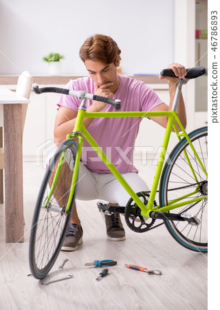 Man repairing his broken bicycle 46786893