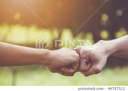 Hands of young man people fist bump team teamwork 46787322