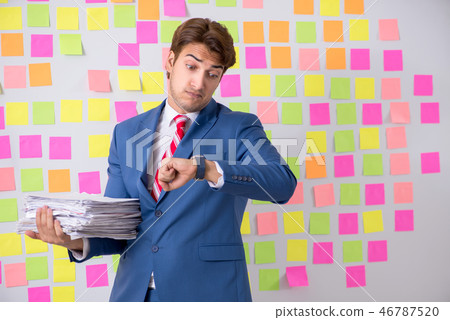 Young handsome man in conflicting priorities concept Young handsome man in conflicting priorities concept 46787520