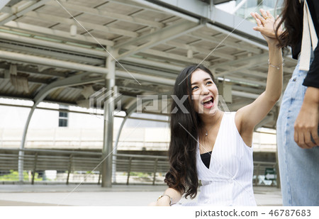Beautiful woman very happy with friends on street. Beautiful woman very happy with friends on street. 46787683