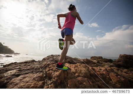 fitness woman trail runner running on seaside 46789673