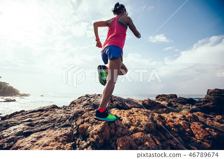 fitness woman trail runner running  on seaside 46789674
