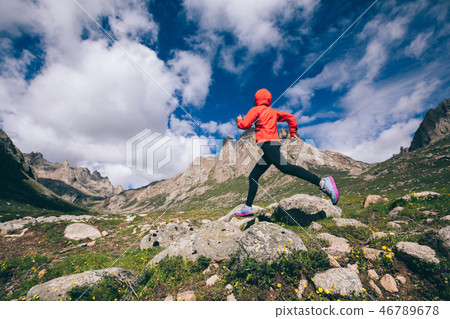 Woman trail runner running on beautiful mountains Woman trail runner running on beautiful mountains 46789678
