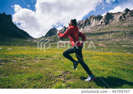 Woman trail runner running on beautiful mountains 46789767