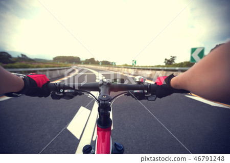 Woman cyclist riding Mountain Bike on highway 46791248