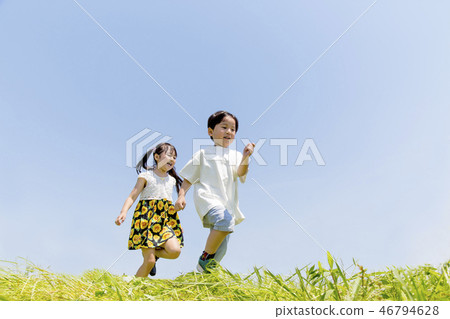 Two sisters running behind the blue sky Two sisters running behind the blue sky 46794628