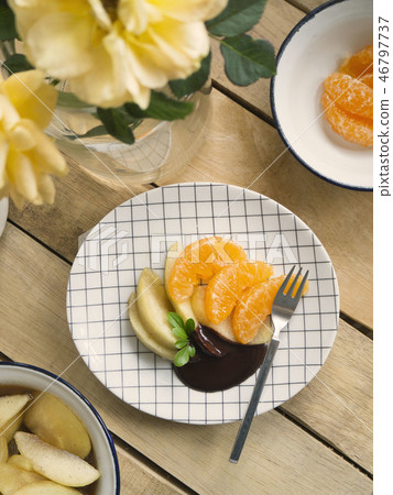 poached apples & fresh orange with chocolate sauce 46797737